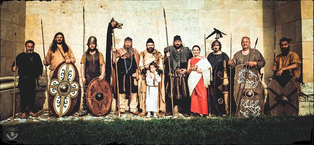 Group portrait in front of a stone wall